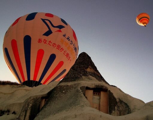 Cappadocia Flying Dress Photoshoot: A Practical Guide Hot-air balloons rising over the fairy chimneys of Göreme at sunrise