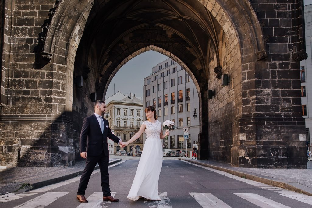 Wedding couple under the Old Town Bridge Tower in Prague